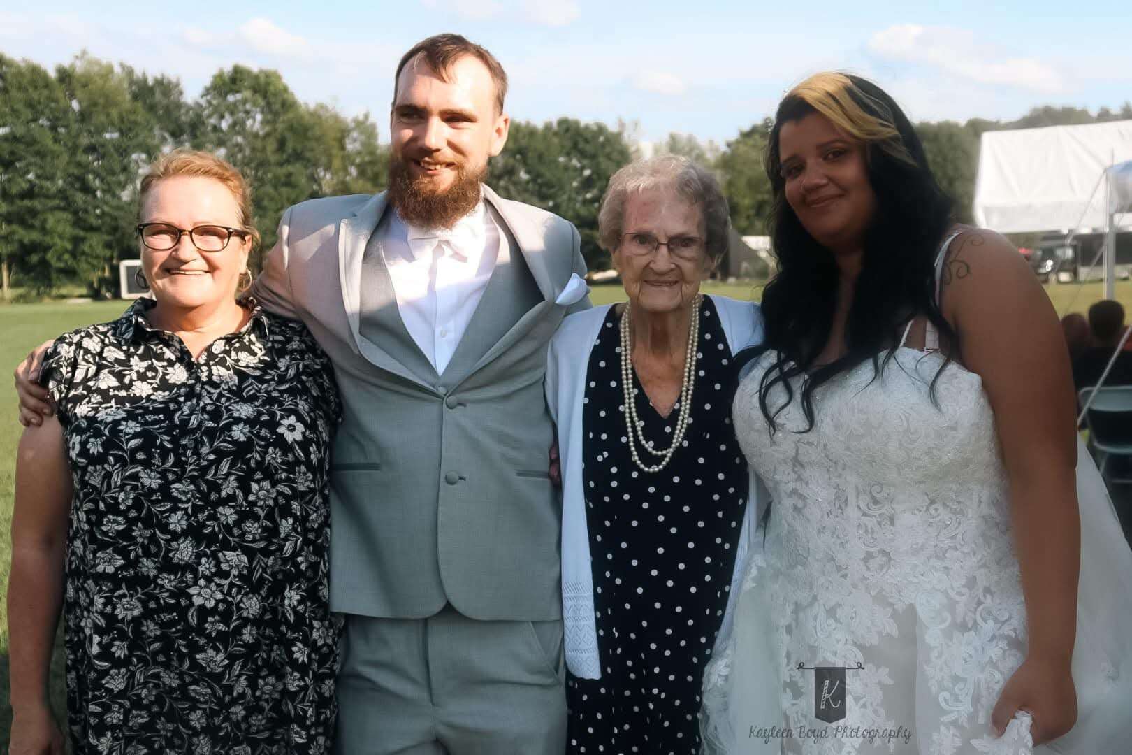 Bride, groom and family at the outdoor summer reception